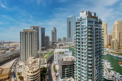 a city skyline with tall buildings and a river at 2BR Retreat in the Heart of Dubai Marina by EE Holiday Homes in Dubai