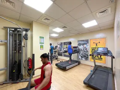 a group of people exercising in a gym at 2BR Retreat in the Heart of Dubai Marina by EE Holiday Homes in Dubai
