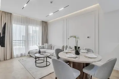a living room with a couch and a table and chairs at 2BR Retreat in the Heart of Dubai Marina by EE Holiday Homes in Dubai