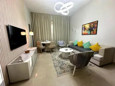 a living room with a couch and a table at Stylish 1BR in Sparkle Towers Dubai Marina Escape in Dubai