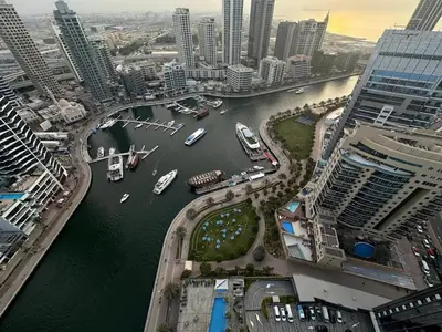 a view of a river with boats in a city at Stylish 1BR in Sparkle Towers Dubai Marina Escape in Dubai