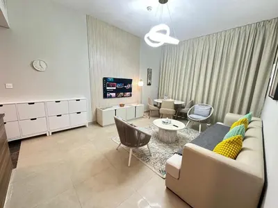 a living room with a couch and a table and chairs at Stylish 1BR in Sparkle Towers Dubai Marina Escape in Dubai