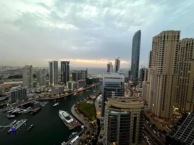 a view of a city with a river and buildings at Stylish 1BR in Sparkle Towers Dubai Marina Escape in Dubai