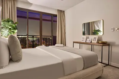 a bedroom with a large bed and a balcony at Royal Amwaj Palm Jumeirah - Luxury 1BR with Pool and Gym in Dubai