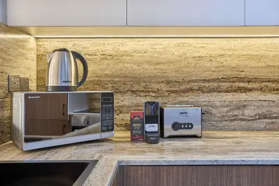 a microwave sitting on top of a kitchen counter at Royal Amwaj Palm Jumeirah - Luxury 1BR with Pool and Gym in Dubai