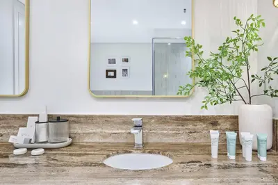 a bathroom with a sink and a mirror at Royal Amwaj Palm Jumeirah - Luxury 1BR with Pool and Gym in Dubai