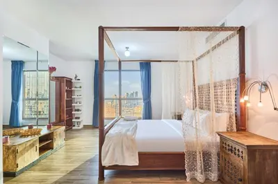 a bedroom with a canopy bed and a large window at 3-Bedroom Residence in Murjan 5 - Jumeirah Beach with Sea Views in Dubai