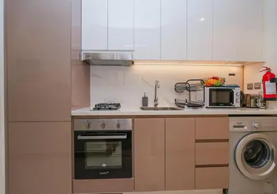 a kitchen with a stove and a microwave at Stylish Meydan Studio with Private Balcony in Dubai
