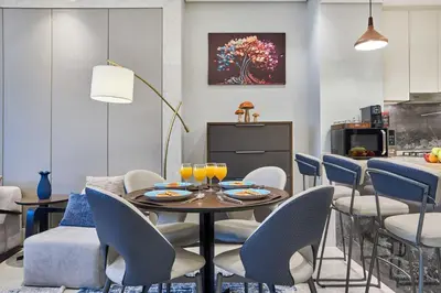 a dining room with a table and chairs at Nobles Tower Business Bay - Modern 1-Bedroom Apartment in Dubai