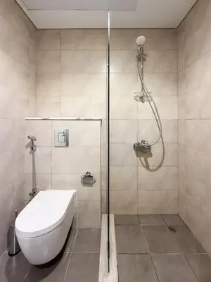 a bathroom with a shower with a toilet and a sink at Nasma Luxury stays- Lavish with luxury facilities in Aykon city in Dubai