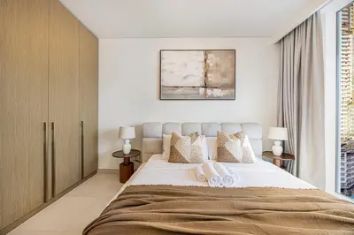 a bedroom with a large bed and a window at Classy Stay at Beach Mansion with Private Beach in Dubai
