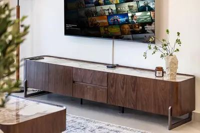a wooden entertainment center in a living room with a tv at Classy Stay at Beach Mansion with Private Beach in Dubai