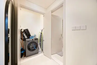 a laundry room with a washing machine and a door at Classy Stay at Beach Mansion with Private Beach in Dubai