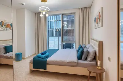 a bedroom with a bed and a large window at Vida Dubai Mall 1BR apt - Connected to Dubai Mall in Dubai
