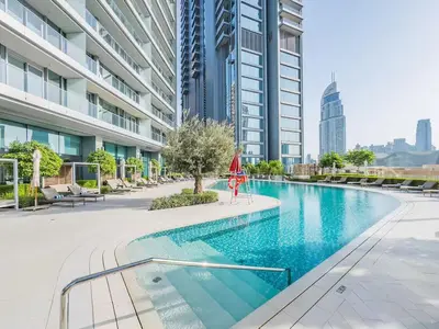 a swimming pool in a city with tall buildings at Vida Dubai Mall 1BR apt - Connected to Dubai Mall in Dubai