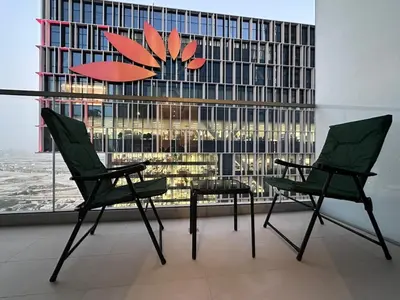 two chairs and a table in front of a window at Vida Dubai Mall 1BR apt - Connected to Dubai Mall in Dubai