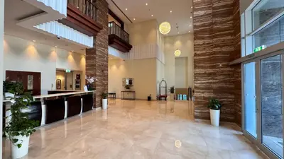 a large lobby with a large stone wall at By Luxury Space I Luxury two Bedroom Apartment I Front row Downtown with Private Fountain View in Dubai