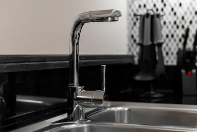 a kitchen sink with a chrome kitchen faucet at Paramount 59th Floor , Burj View Infinity Pool in Dubai