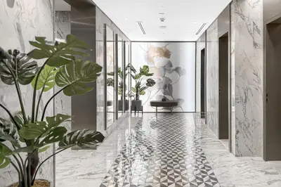 a hallway with potted plants and a statue at Paramount 59th Floor , Burj View Infinity Pool in Dubai