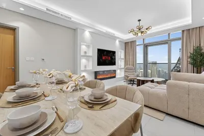 a living room with a dining table and a couch at Paramount 59th Floor , Burj View Infinity Pool in Dubai