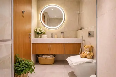 a bathroom with a teddy bear sitting on a toilet at Luxury Studio with Pool and Parking at Azizi Vista in Dubai