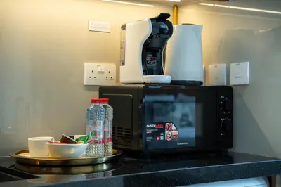 a microwave sitting on top of a kitchen counter at Luxury Studio with Pool and Parking at Azizi Vista in Dubai