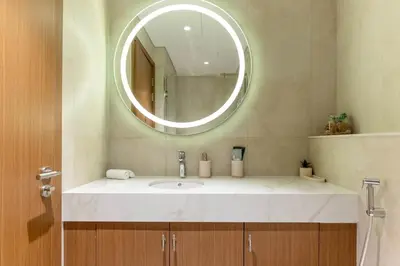 a bathroom with a sink and a mirror at Luxury Studio with Pool and Parking at Azizi Vista in Dubai