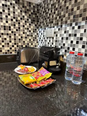 a counter with two plates of food and bottles of water at Artistic Studio in Cayan Tower with Marina Views in Dubai