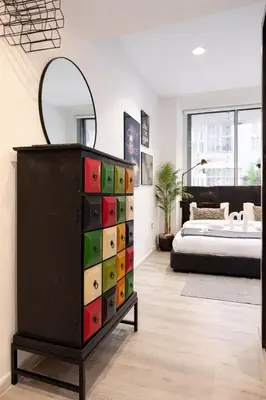 a dresser in a bedroom with a bed at Artistic Studio in Cayan Tower with Marina Views in Dubai