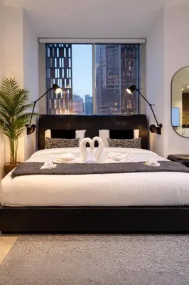 a bedroom with a large bed with two wedding towels at Artistic Studio in Cayan Tower with Marina Views in Dubai