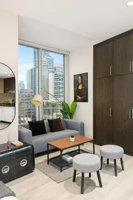a living room with a couch and a table at Artistic Studio in Cayan Tower with Marina Views in Dubai