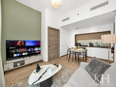 a living room with a couch and a tv at keylid Premium 1BR Apartment Dubai Marina in Dubai