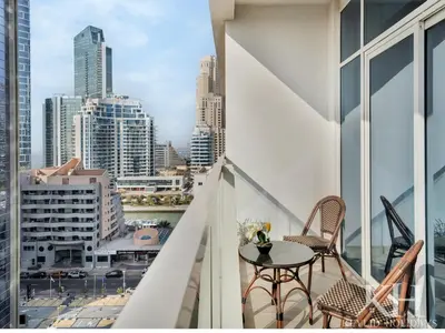 a balcony with a table and chairs and a city at keylid Premium 1BR Apartment Dubai Marina in Dubai