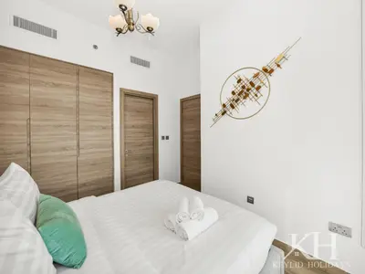 a bedroom with a bed with two towels on it at keylid Premium 1BR Apartment Dubai Marina in Dubai