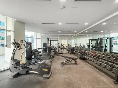 a gym with lots of treadmills and exercise bikes at FIRST CLASS Studio Canal & Burj Khalifa View in Dubai