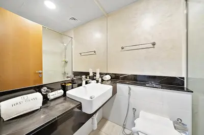 a bathroom with a sink and a mirror at FIRST CLASS Studio Canal & Burj Khalifa View in Dubai
