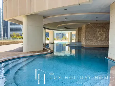 a swimming pool in the middle of a building at LUX The 02 Residences JLT Suite in Dubai