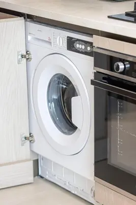 a washing machine and a microwave in a kitchen at Binghatti Phoenix - Luxury & Modern Studio - Pool & Gym - Free Parking - JVC in Dubai