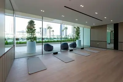 a room with yoga mats and chairs and windows at Binghatti Phoenix - Luxury & Modern Studio - Pool & Gym - Free Parking - JVC in Dubai