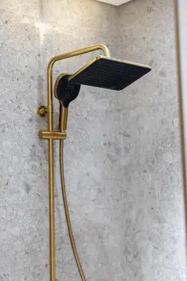 a shower with a shower head in a bathroom at Binghatti Phoenix - Luxury & Modern Studio - Pool & Gym - Free Parking - JVC in Dubai