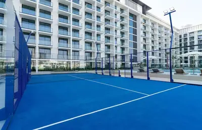a tennis court in front of a building at Binghatti Phoenix - Luxury & Modern Studio - Pool & Gym - Free Parking - JVC in Dubai