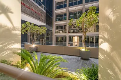 a rendering of a building with trees in a courtyard at FIRST CLASS 2BR Modern Luxury Hideaway in Dubai