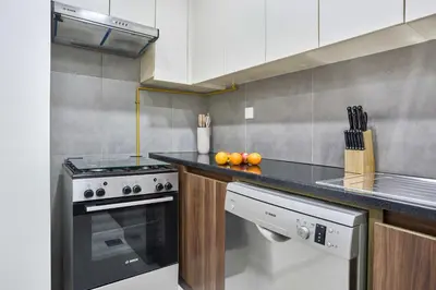 a kitchen with a stove and a counter top at Modern 2-Bedroom Retreat in Remraam - Al Ramth 5 in Dubai
