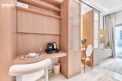 a living room with a table and a chair at bnbmehomes - Burj Al Nujoom in Dubai