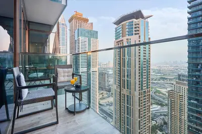 a balcony with a view of a city at Jumeirah Living Marina Gate - Elegant 1BR Canal View Retreat in Dubai