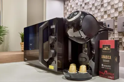 a coffee maker sitting on top of a microwave at Jumeirah Living Marina Gate - Elegant 1BR Canal View Retreat in Dubai