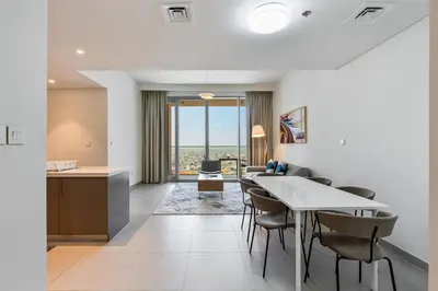 a kitchen and dining room with a table and chairs at Elegant 2Bed Walk to Burj Khalifa & Dubai Mall in Dubai