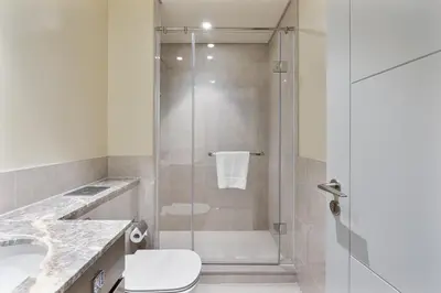 a bathroom with a shower with a toilet and a sink at Elegant 2Bed Walk to Burj Khalifa & Dubai Mall in Dubai