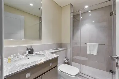a bathroom with a toilet and a sink and a shower at Elegant 2Bed Walk to Burj Khalifa & Dubai Mall in Dubai