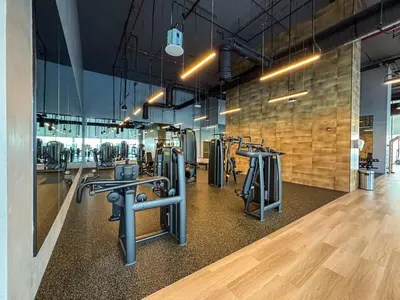 a gym with several rows of exercise equipment in a room at Elegant 2Bed Walk to Burj Khalifa & Dubai Mall in Dubai